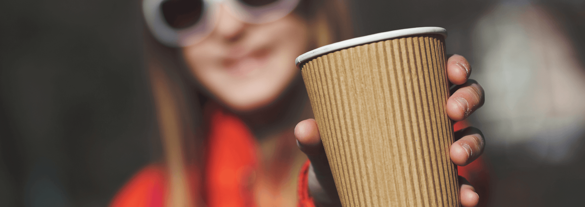 Woman using a single use coffee cup